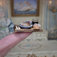 Load image into Gallery viewer, Miniature food and drink set on a wooden tray held by a hand, with a blurred background