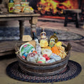 Load image into Gallery viewer, Gourmet gift basket with cheeses, meats, and bread on a woven mat.