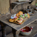 Load image into Gallery viewer, Miniature food items on a wooden table with a rustic background