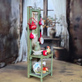 Load image into Gallery viewer, Miniature green shelf with decorative items against a blurred indoor background