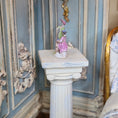 Load image into Gallery viewer, Decorative figurine on a pedestal against an ornate wall.