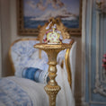 Load image into Gallery viewer, Decorative figurine on a gold pedestal in a room with a painting in the background