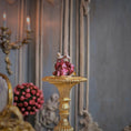 Load image into Gallery viewer, Decorative sculpture on a gold pedestal in an elegant room with pink flowers and a candelabra.