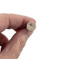 Load image into Gallery viewer, Hand holding a small cork with a number '15' on a white background