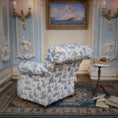 Load image into Gallery viewer, Blue and white patterned armchair in a decorative room with a painting on the wall.