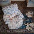 Load image into Gallery viewer, Vintage-style armchair with blue floral pattern on a patterned rug