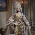 Load image into Gallery viewer, Detailed doll in a historical costume holding a dish, set against an elegant interior background.