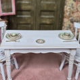 Load image into Gallery viewer, White table with miniature plates and chairs in a vintage setting