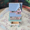 Load image into Gallery viewer, Laura Eppich 1:144 Lavender & Blue Three-Story Victorian Dollhouse on Blue Table