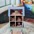 Load image into Gallery viewer, Laura Eppich 1:144 Lavender & Blue Three-Story Victorian Dollhouse on Blue Table
