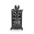 Load image into Gallery viewer, A miniature gothic-style black cabinet display with glass doors, filled with small decorative items including a gargoyle figurine, books, crystals, and old papers, shown on a plain white background.