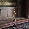 Load image into Gallery viewer, Gold Buddha statue on a wooden shelf with a blurred background