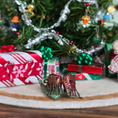 Load image into Gallery viewer, back of pair of leather dollhouse miniature elf shoes with a Christmas tree and presents in the background