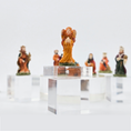 Load image into Gallery viewer, Decorative nativity angel miniature dollhouse figurine on a clear stand with other figurines in the background.