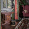 Load image into Gallery viewer, Decorative interior with a wooden table, chair, stained glass window and a waste basket.