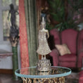 Load image into Gallery viewer, Silver Buddha statue on a round table with a blurred indoor background