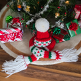 Load image into Gallery viewer, Dollhouse miniature Knitted Christmas hat and scarf with a small tree and presents in the background.