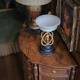 Load image into Gallery viewer, Decorative sculpture with gold and black base on a wooden table