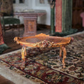 Load image into Gallery viewer, Decorative wooden table with floral carvings on a patterned rug