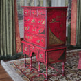Load image into Gallery viewer, Red vintage cabinet with intricate designs in a room with patterned rug and curtains, Alan Barnes