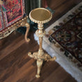 Load image into Gallery viewer, Decorative gold candle stand on a wooden floor with a blurred background