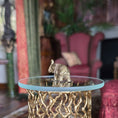 Load image into Gallery viewer, Decorative table with a gold elephant sculpture in a room with pink chairs and a plant.
