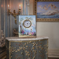 Load image into Gallery viewer, Decorative clock with artistic design on a ornate cabinet in an elegant room.