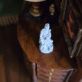 Load image into Gallery viewer, Small white statue on a wooden surface with a blurred background