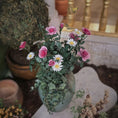 Load image into Gallery viewer, Bouquet of pink roses and white daisies in a planter on a decorative surface.