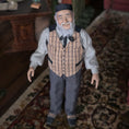 Load image into Gallery viewer, Vintage-style Asian clay dollhouse doll - an elderly man with a beard on a patterned rug.