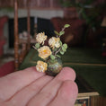 Load image into Gallery viewer, Hand holding a miniature vase with yellow flowers against a blurred indoor background