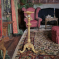 Load image into Gallery viewer, Decorative gold pedestal in a room with furniture and a fireplace, John J. Hodgson