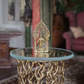 Load image into Gallery viewer, Decorative gold statue on a glass table with a blurred indoor background
