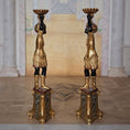 Load image into Gallery viewer, Pair of ornate gold and black pedestal stands in a classical setting by John J. Hodgson