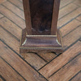 Load image into Gallery viewer, Close-up of a wooden pedestal with decorative trim on a wooden floor.