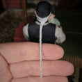 Load image into Gallery viewer, Detail close up of clay dollhouse doll's braided white hair held in a hand against a blurred background