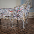 Load image into Gallery viewer, Decorative floral-patterned chaise with gold accents on a wooden floor.