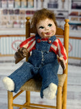 Load image into Gallery viewer, Messy Little Boy Doll with Overalls & Ice Cream Cone, sitting in chair