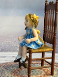 Load image into Gallery viewer, Bonnie Justice Sculpted Seated Little Blonde Girl Doll in Blue Dress, left side