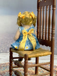 Load image into Gallery viewer, Bonnie Justice Sculpted Seated Little Blonde Girl Doll in Blue Dress, back view