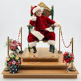 Load image into Gallery viewer, Santa Claus dollhouse doll sitting in a chair with Christmas decorations around.
