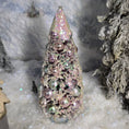 Load image into Gallery viewer, Decorative Christmas tree cone with pink glitter and beads on a snowy background