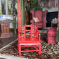 Load image into Gallery viewer, Red oriental chair in a decorated room with a fireplace and ornate furniture.