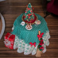 Load image into Gallery viewer, Decorative Christmas tablecloth with a small tree, presents, and other ornaments on a wooden surface.