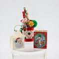 Load image into Gallery viewer, Christmas-themed gift bag with Santa Claus design on a white surface