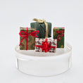 Load image into Gallery viewer, Decorative gift boxes with ribbons on a white stand against a light gray background