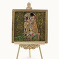 Load image into Gallery viewer, Artistic depiction of 'The Kiss' by Gustav Klimt in miniature by Sam Kelm on a decorative easel with a white background