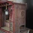 Load image into Gallery viewer, Traditional wooden Asian wedding bed alcove with intricate carvings and a lantern on a dark background
