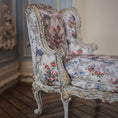 Load image into Gallery viewer, Decorative chaise with floral pattern and gold accents in a room setting.
