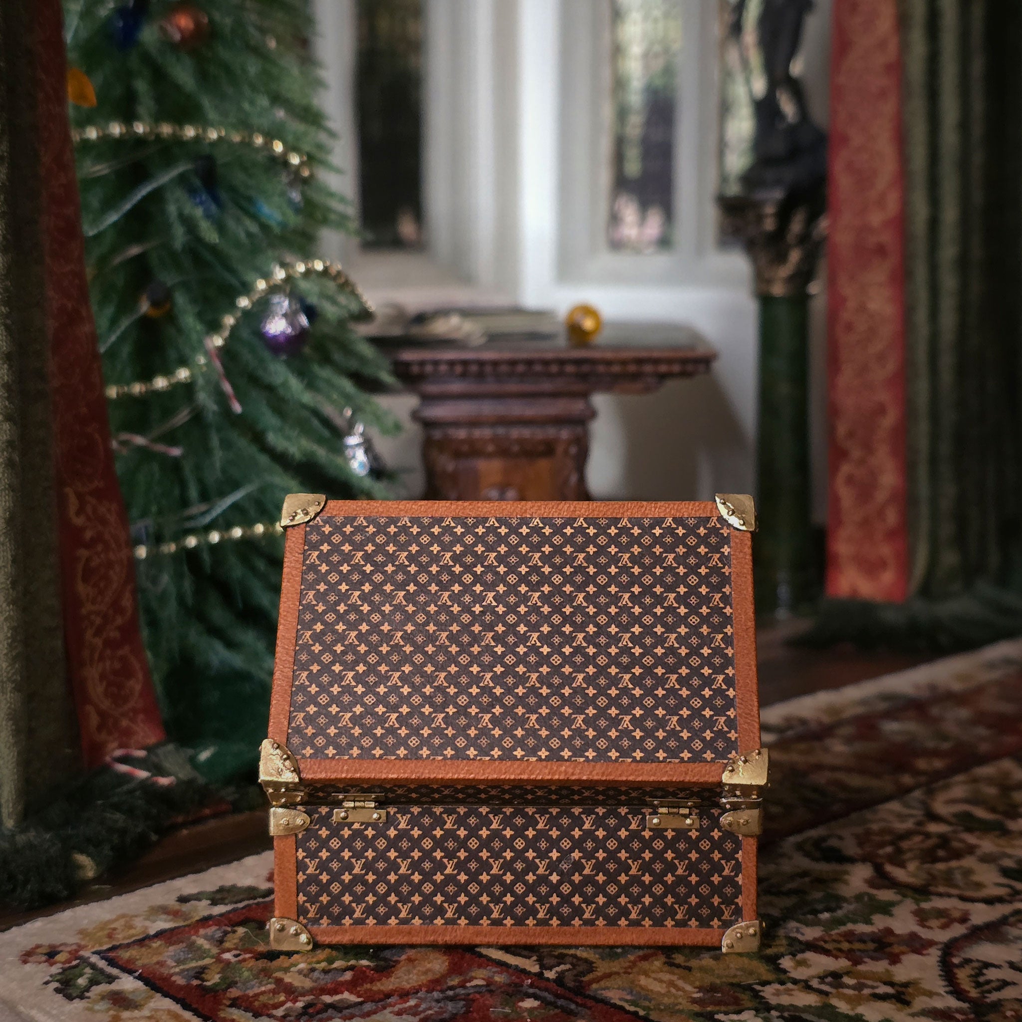 Decorative chest with intricate patterns in a festive room with a Christmas tree.